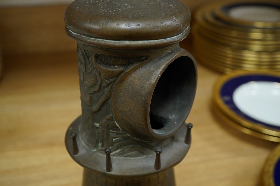 A bronze 'lighthouse' clock case with Chinese repoussé decoration, 30cm. Condition - fair to good